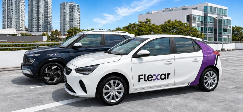 Two Flexar shared cars on a rooftop car park in Singapore